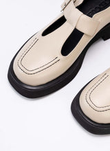 Lade das Bild in den Galerie-Viewer, Detailfoto eines cremefarbenen Mary Jane Schuhs aus Echtleder. Als Kontrast wurden schwarzes Lederfutter, eine schwarze Laufsohle und schwarzes Lederfutter verwendet. Die Schuhfront wird von einer Wulstnaht mit schwarzem Stitching geziert.